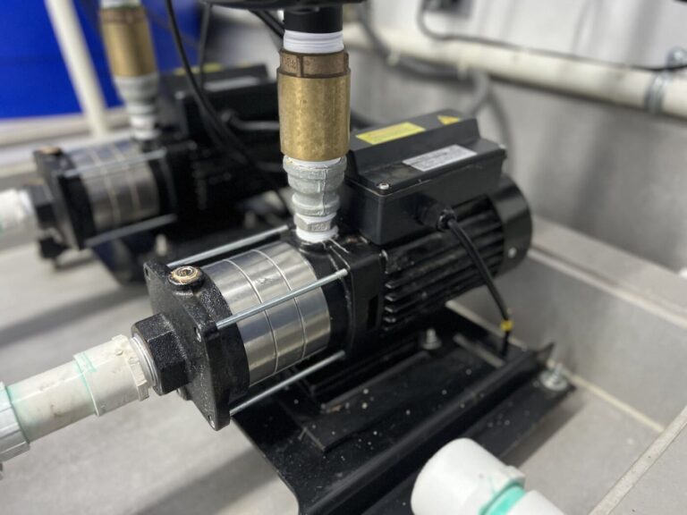 Residential fire sprinkler pump with connected piping and motor assembly.