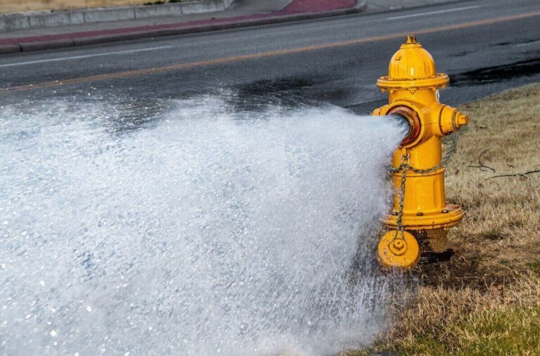 Fire hydrant flowing water during a fire flow test to measure pressure and available water supply for sprinkler system design